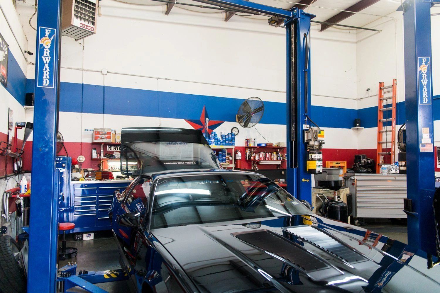 Pro Automotive Repair shop interior with car on lift in Sachse TX