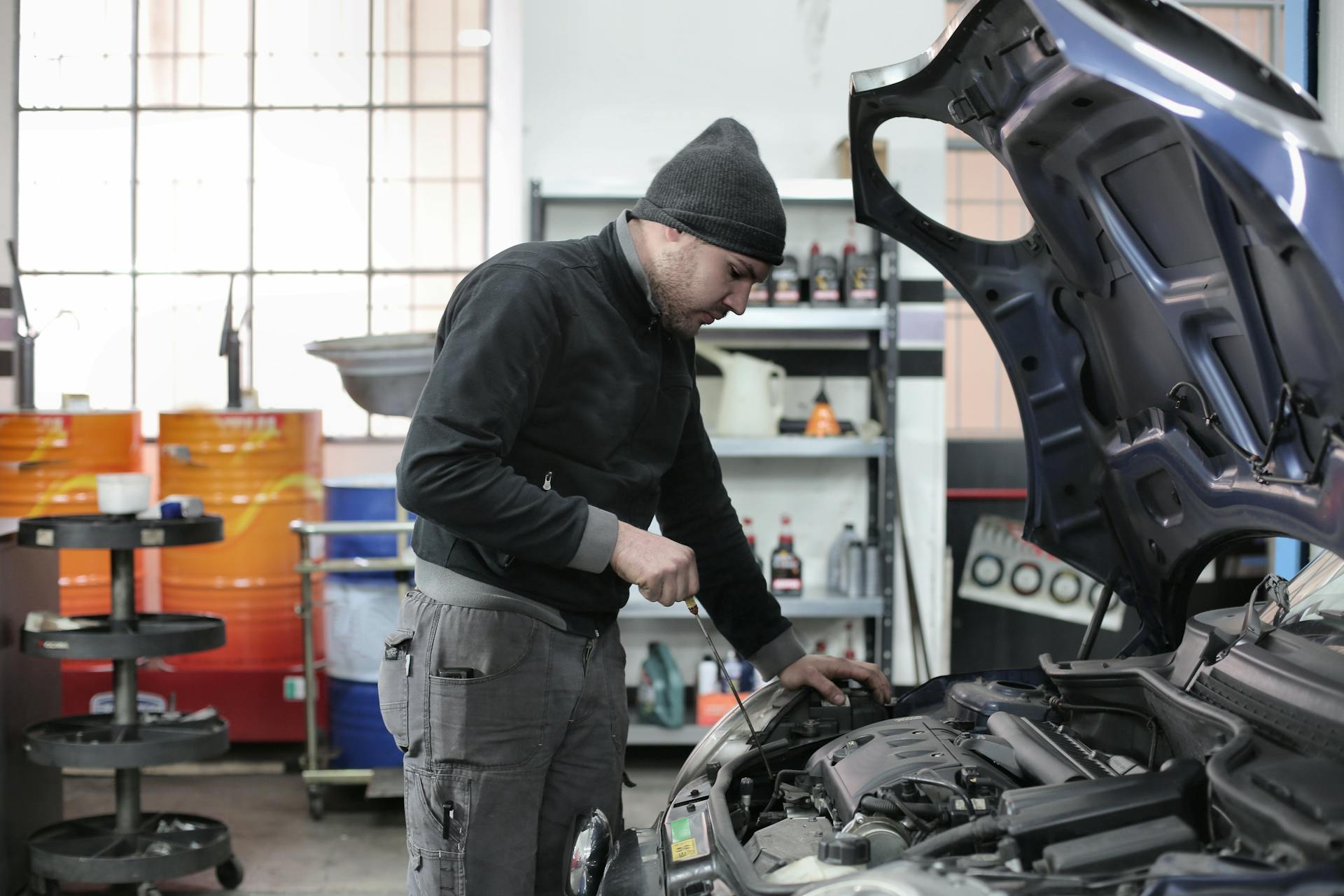 Mechanic performing preventive maintenance on vehicle at Pro Automotive Repair