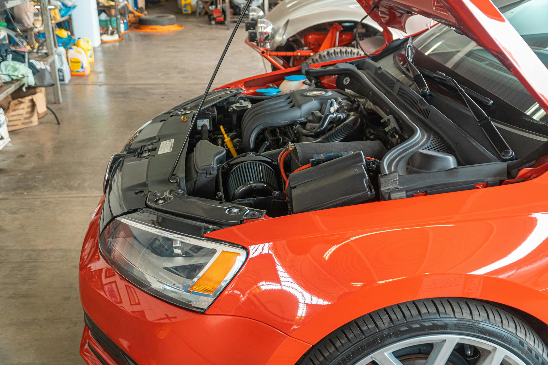Engine bay with hood open showing engine components being serviced