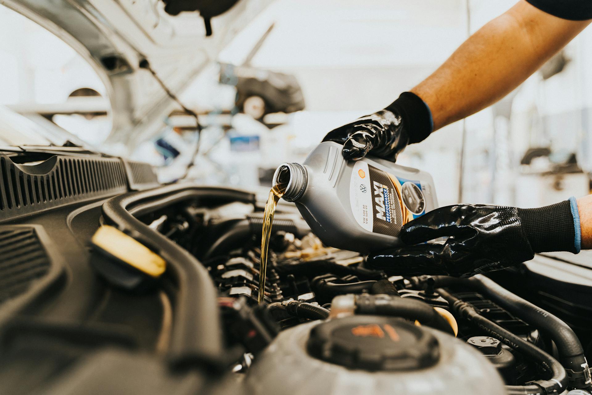 Mechanic pouring fresh oil during oil change service at Pro Automotive Repair in Sachse TX